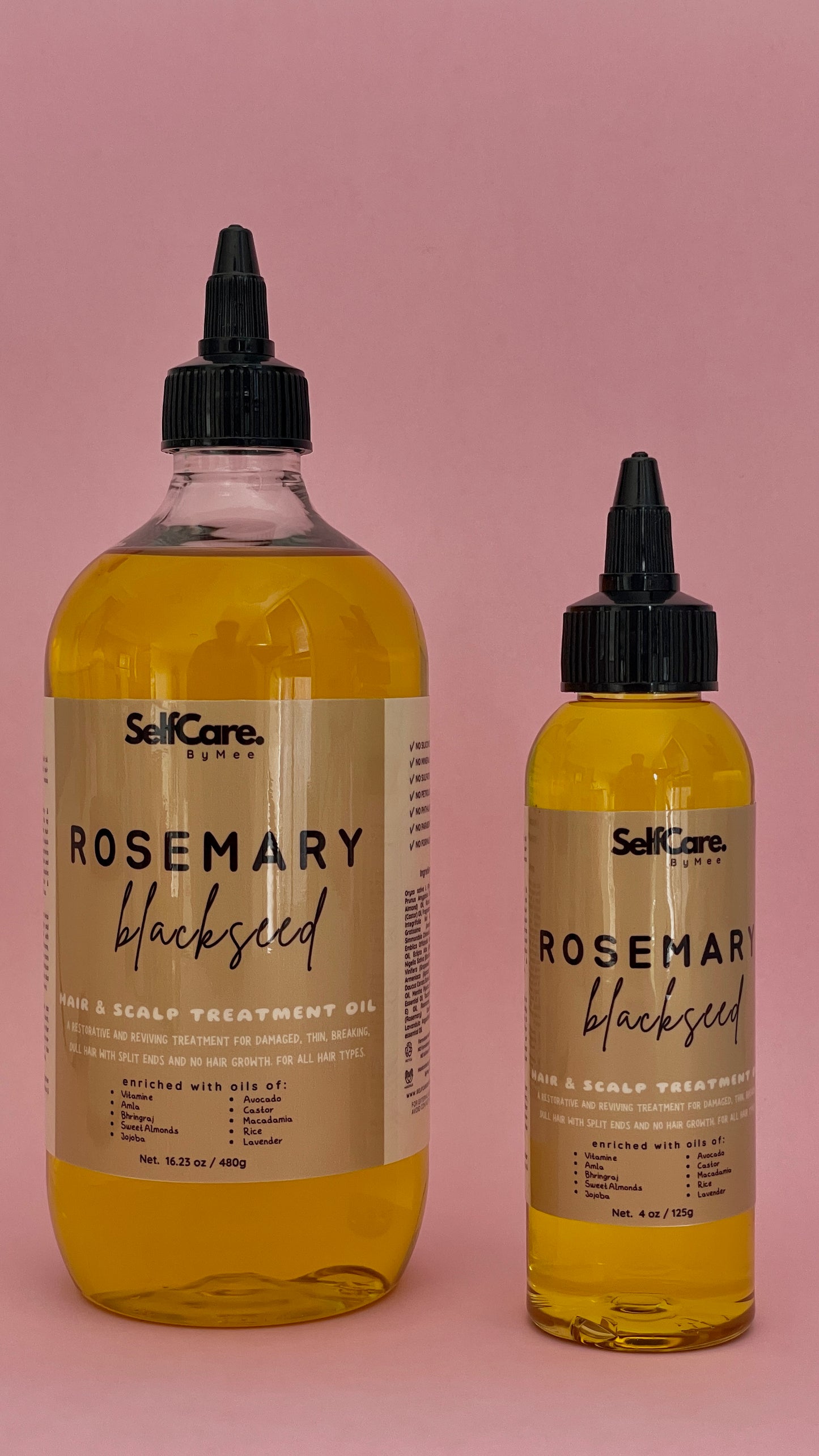 Two bottles of SelfCare by Mee Rosemary Blackseed Hair Scalp Treatment Oil in a pink studio background, featuring a large 4oz bottle and a smaller 1oz bottle.