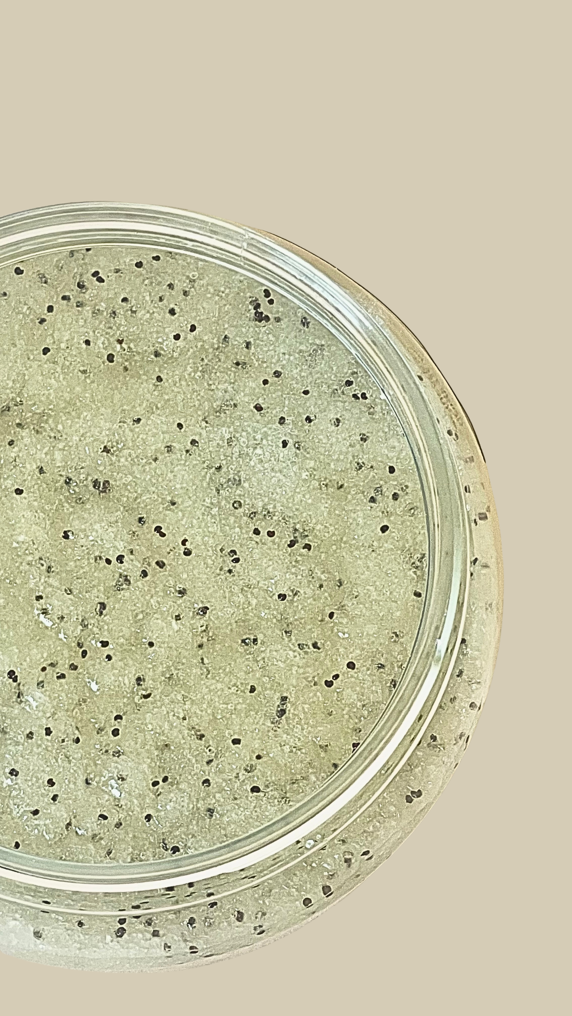Close-up of a container with a scrub on a beige background