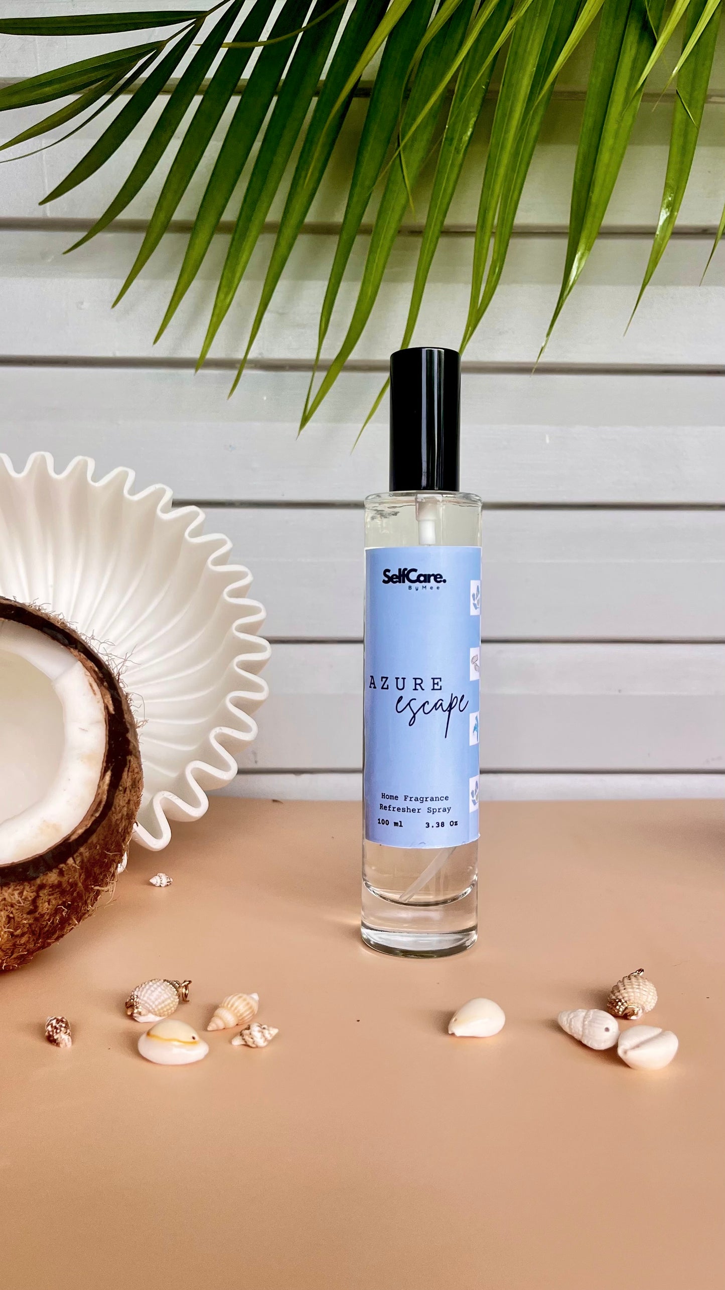 Perfume bottle labeled 'Azure Escape' on a wooden surface with coconut and shells, against a light wooden panel background.