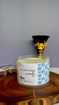 Candle labeled 'Midnight Woods' on a wooden surface with a gray background