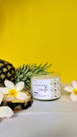 Tropical vanilla candle with a pineapple and flowers on a yellow background