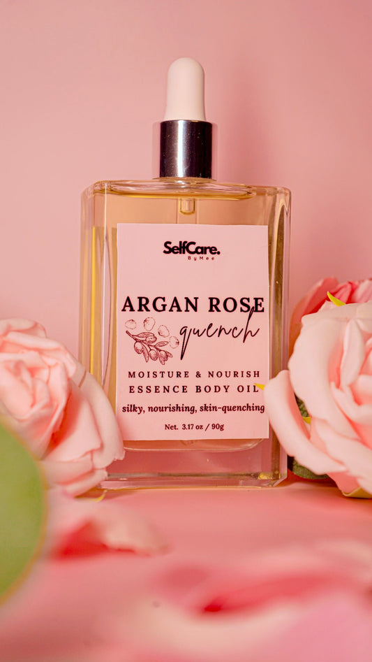Bottle of SelfCare Argan Rose Quench essence body oil with pink roses on a pink background